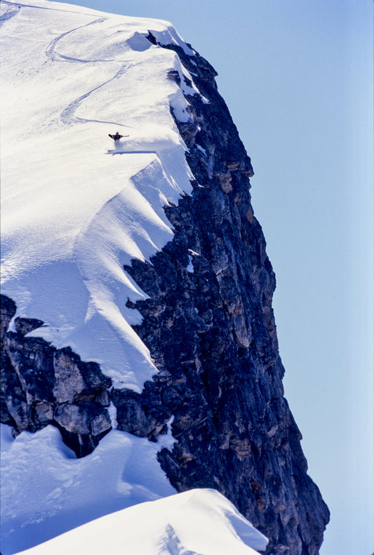 Snowboarder Axel Pauporté rides dangerously close to a sheer cliff