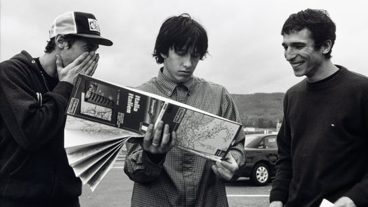 Snowboarders reading a roadmap while lost in Italy.