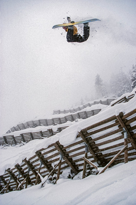 Snowboarder Tommy Brunner does a method air off an avalanche barrier in Austria