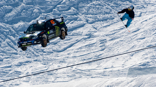 Gymkhana rally driver Ken Block and snowboarder Torstein Horgmo go off a jump together 