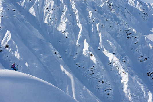 Snowboarder Gigi Rüf looking across the valley at his next run