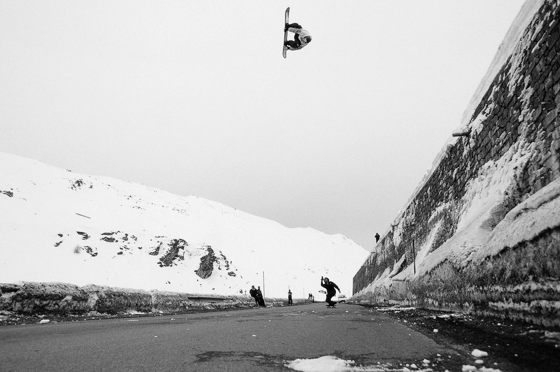 Professional snowboarder JP Solberg jumping over a road gap