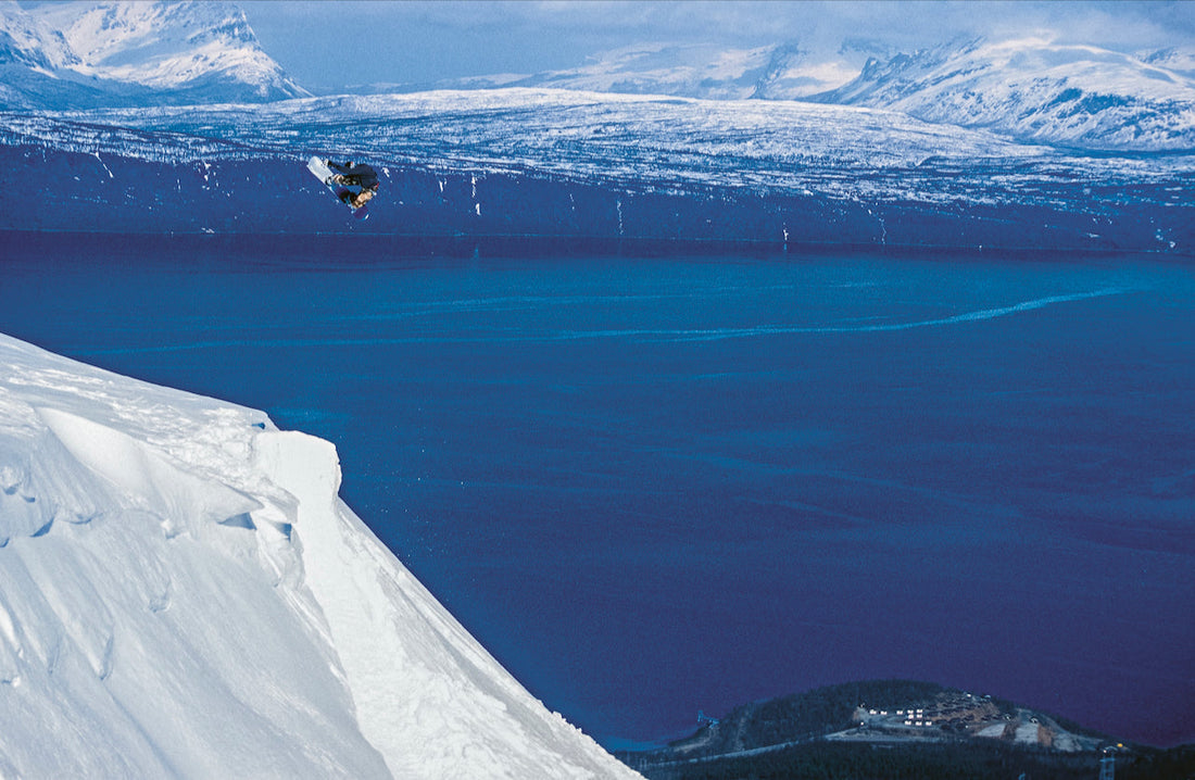 Snowboarder Torgeir Nordkild jumping above a Norwegian fjord