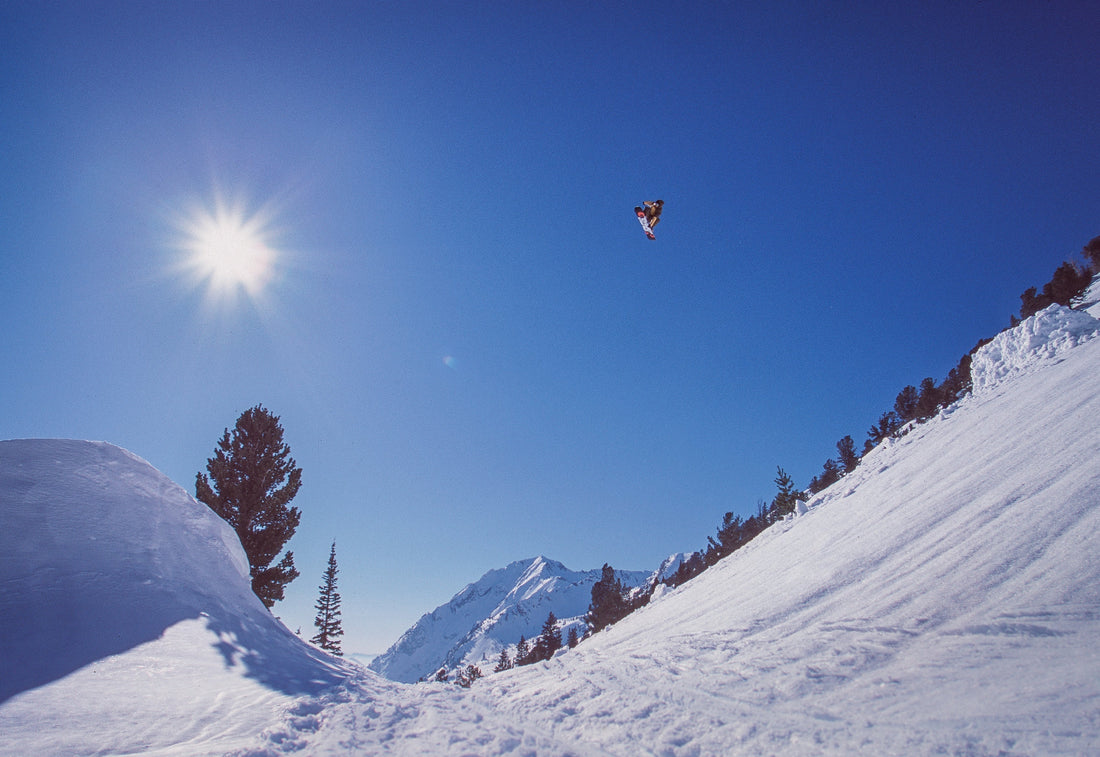 Snowboarder Travis Rice Jumping Over Chad’s Gap