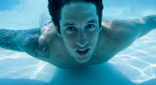 Snowboarder Romain De Marchi swimming under water